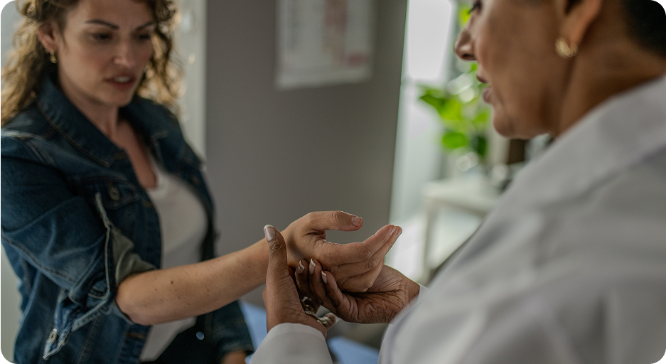 Doctor examiniming a patient's wrist to determine if they are showing signs of rheumatoid arthritis. 