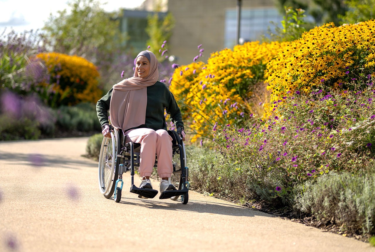 A woman in a wheelchair enjoying an outdoor garden