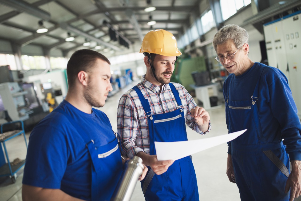 Supplier with engineer checking on production in factory
